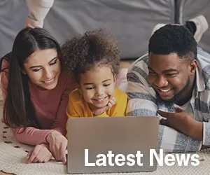 family looking at laptop